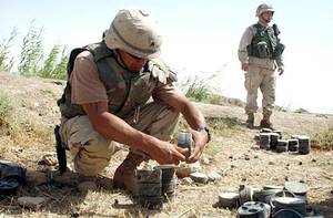 A U.S. Army engineer removing the fuse from a Russian-made mine in order to clear a minefield outside of Fallujah, Iraq
