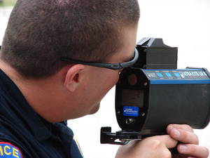 Texas police officer using a LIDAR laser speed detection gun