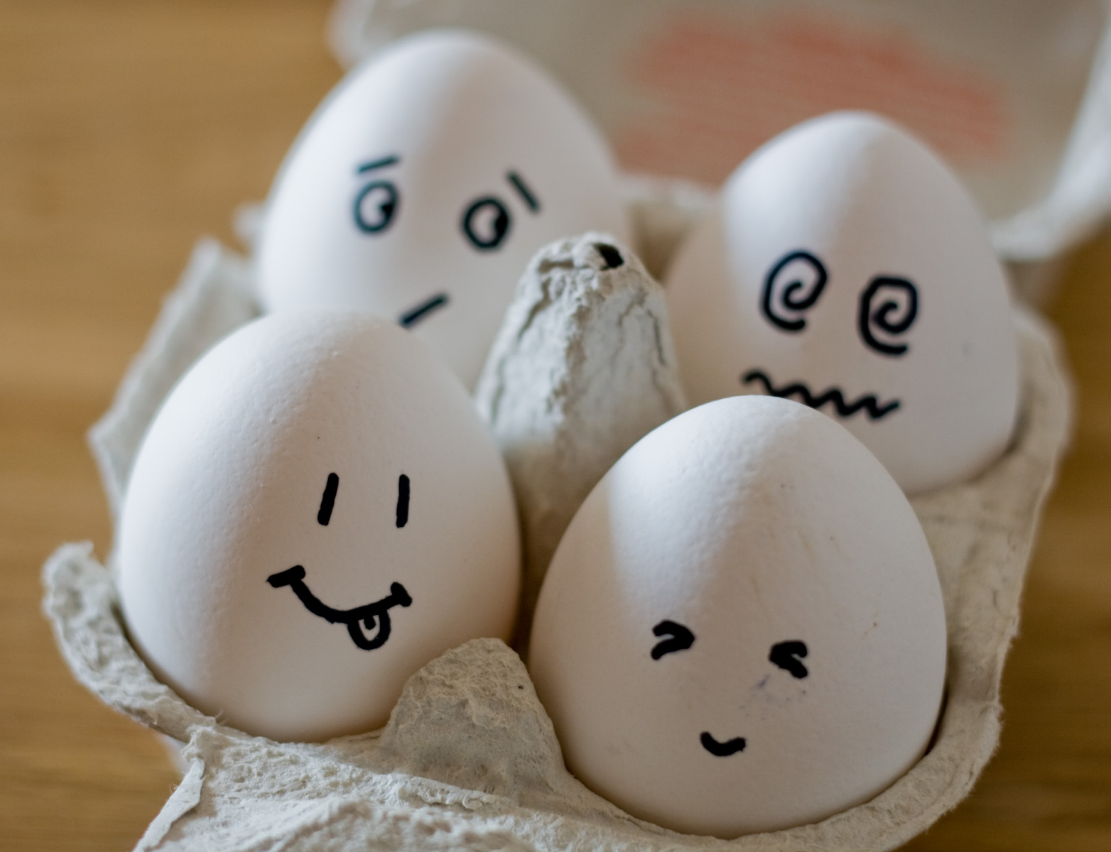 Eggs in an egg box, with faces