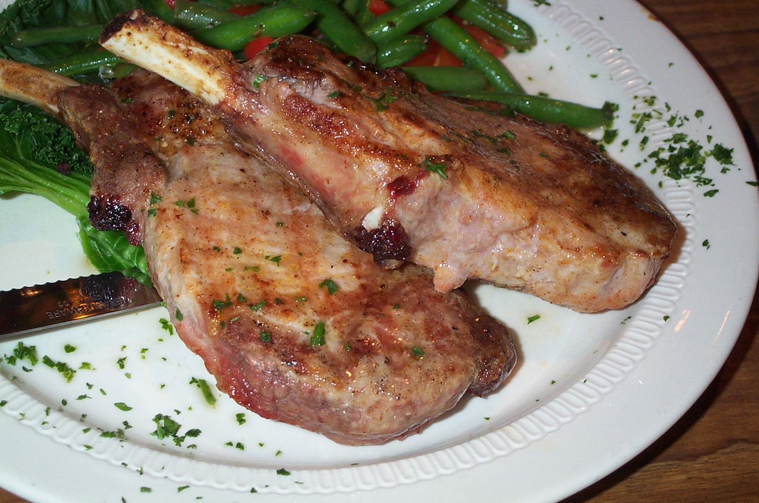 A plate of cooked pork chops.