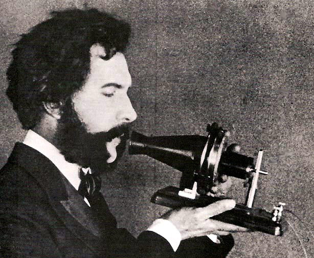 Alexander Graham Bell speaking into a prototype telephone