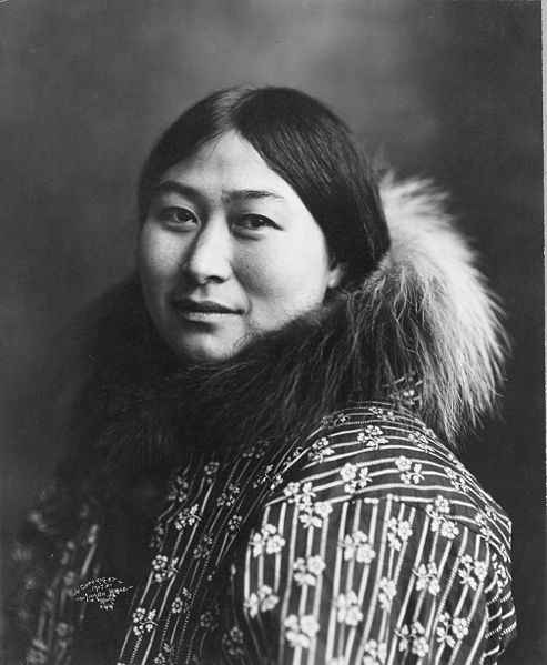 Photograph of an Alaska Native woman wearing a coat with a fur collar.