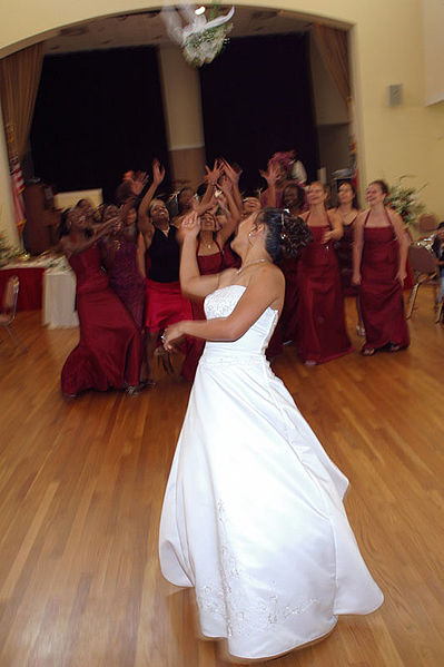 A bride tossing her bouquet of flowers