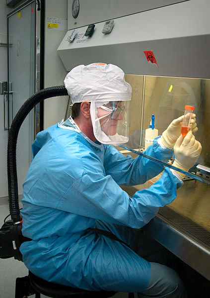  This 2005 photograph of the Centers for Disease Control and Preventions Dr. Terrence Tumpey, one of the organizations staff microbiologists and a member of the National Center for Infectious Diseases (NCID), showed him examining reconstructed 1918...