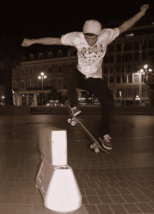 An attempt to ollie over a barrier on a skateboard