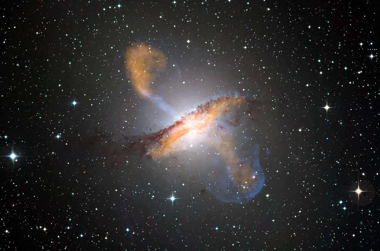 This composite of visible, microwave (orange) and X-ray (blue) data reveals the jets and radio-emitting lobes emanating from Centaurus A's central black hole.