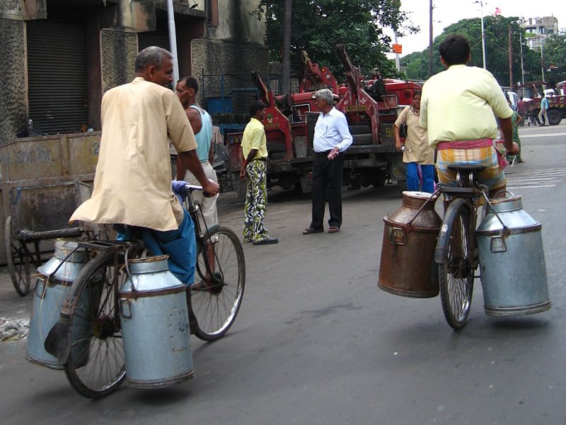 Milk churns being carried on bicycles, Kolkata, India.