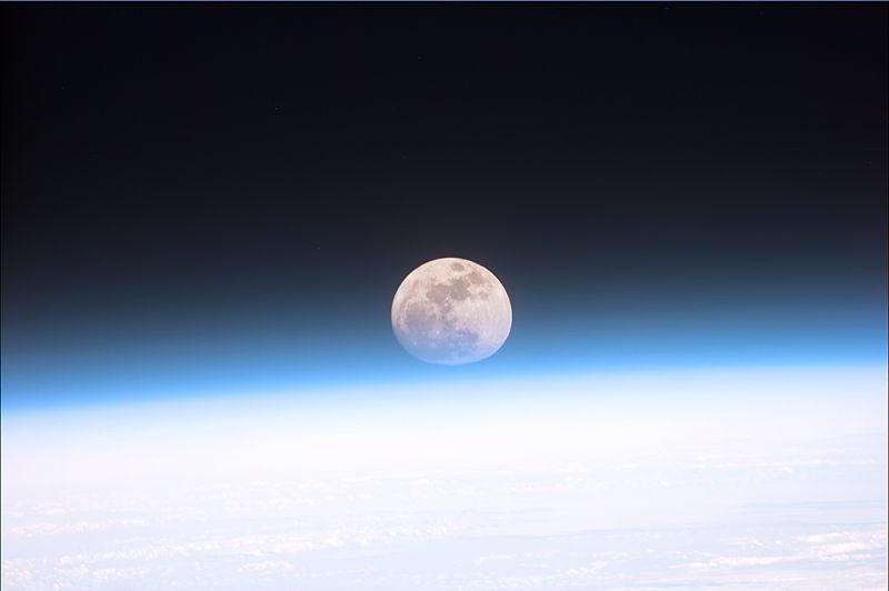 The moon partially obscured by the atmosphere