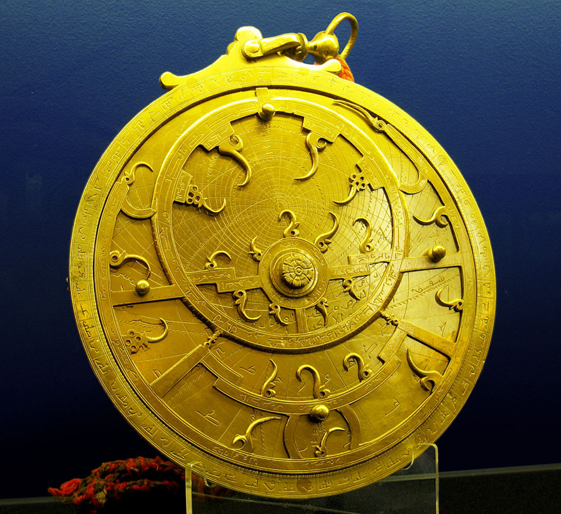  An 18th Century Persian astrolabe - maker unknown. The points of the curved spikes on the front ''rete'' plate, mark the positions of the brightest stars. The name of each star being labeled at the base of each spike. The back plate, or ''mater'' is...