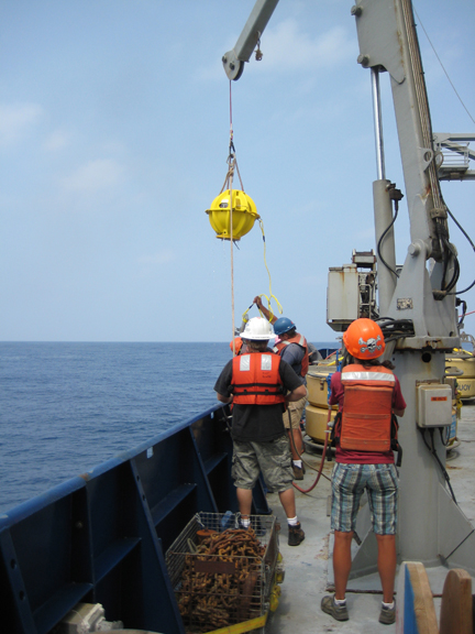 DOV Karen brought onboard - glass buoyancy and communication sphere seen in yellow housing.