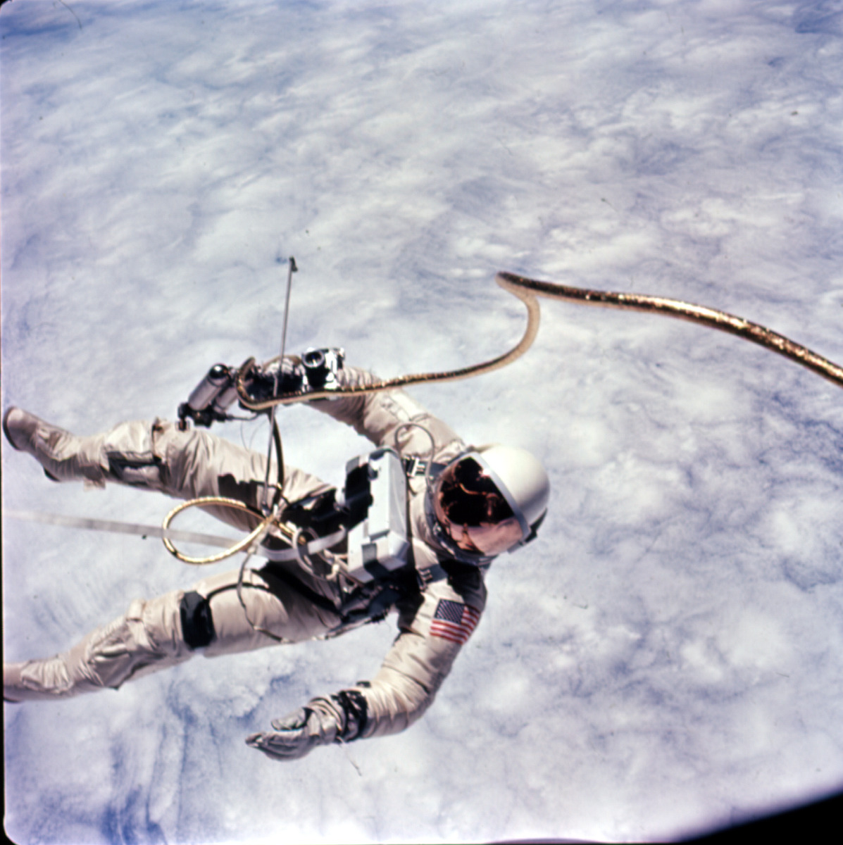  This photograph was taken early in the EVA over a cloud-covered Pacific Ocean. Astronaut Edward H. White II, pilot for the Gemini-Titan 4 space flight, floats in zero gravity of space. The extravehicular activity was performed during the third...