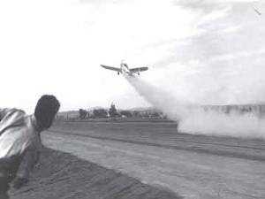 Figure 3: Jack Parsons rushes to measure the take-off distance for his rocket-powered Ercoupe plane in 1941.