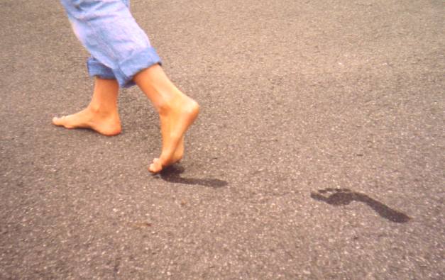 Healthy feet of an 11-year-old girl who regularly goes barefoot. Note the presence of ideal arches, looking at her footprints on the dirty floor.