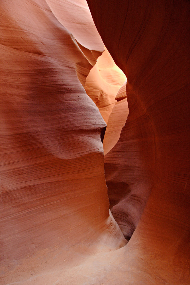 Inside Lower Antelope Canyon, featuring red sandstone corridors.