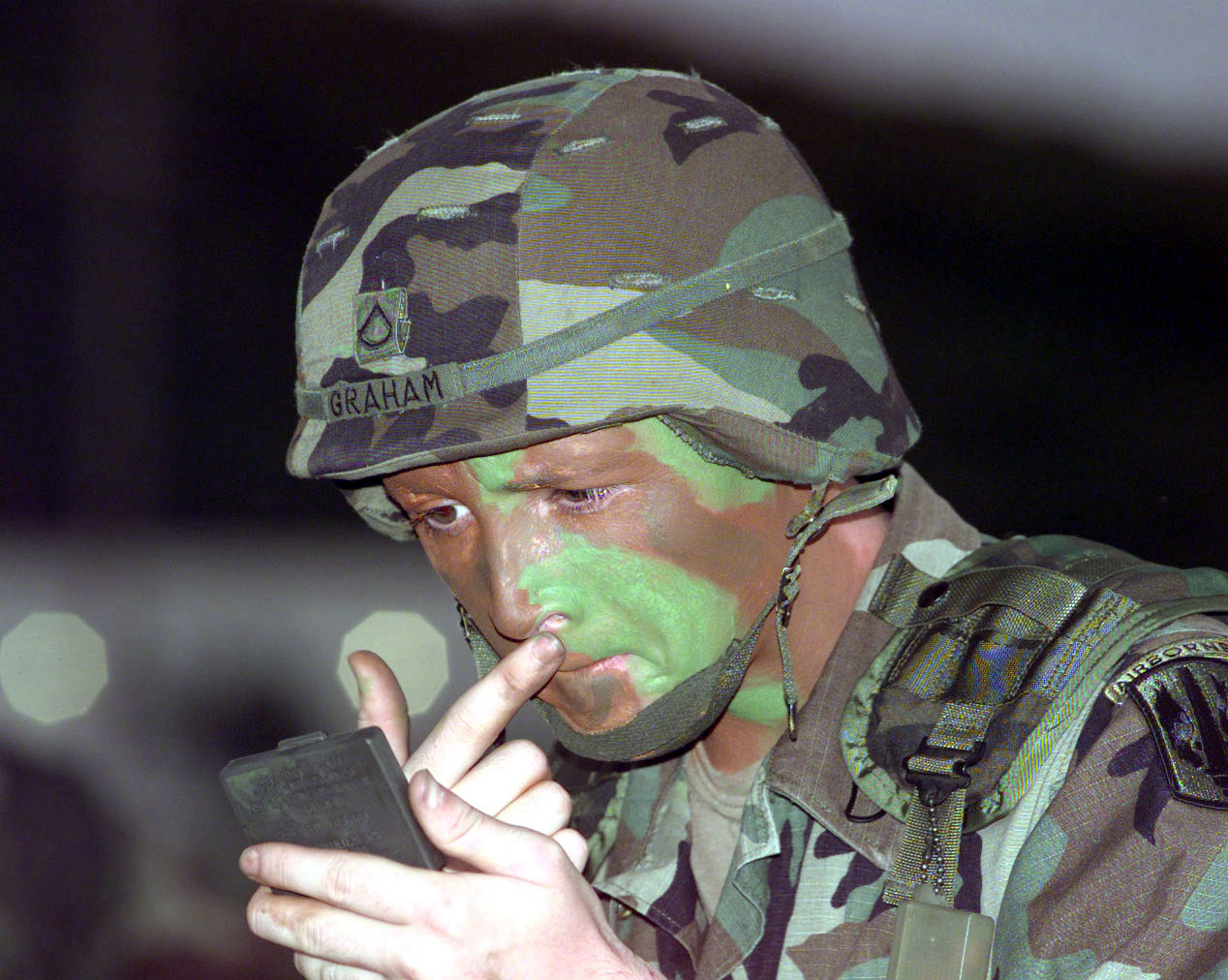 PFC Joel Graham puts on camouflage paint
