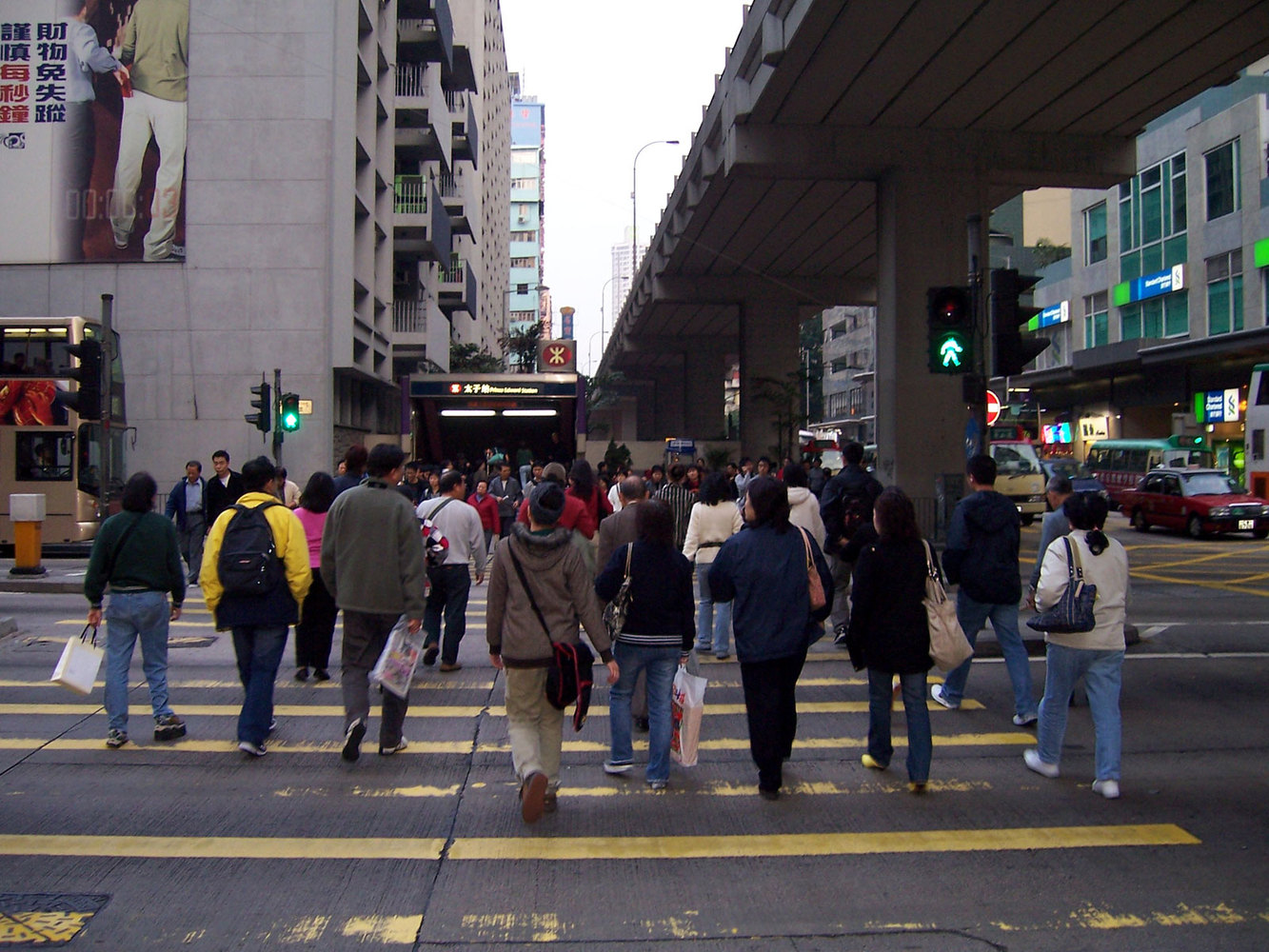 Pedestrians cross a road in Mong Kok