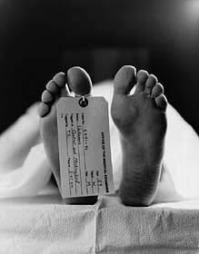 A toe tag is put on a toe of a dead body for identification reasons in morgues