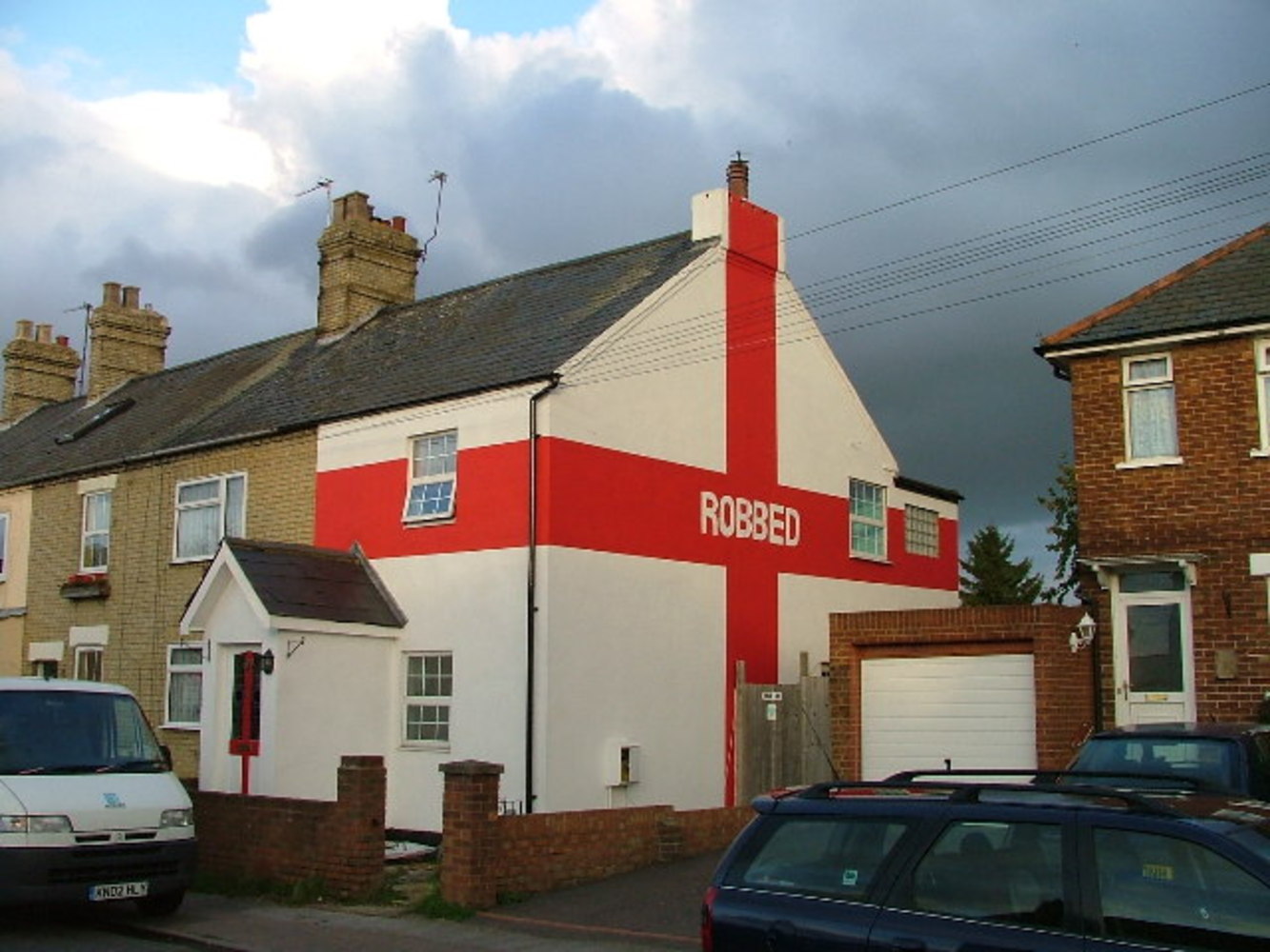 We wuz robbed. I understand that this house was painted this way after England lost to Portugal 6-5 on penalties in Euro 2004, in controversial circumstances.