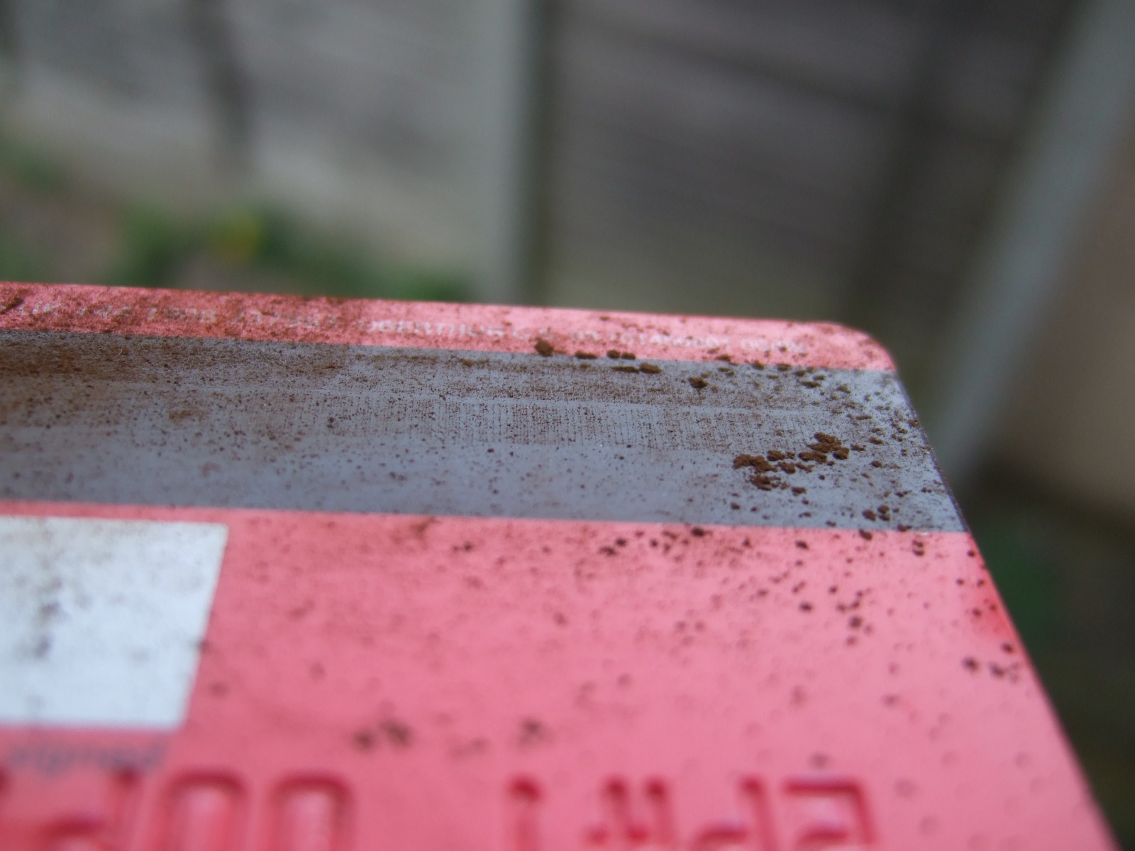 Fine particles of rust show up the magnetic lines on a credit card