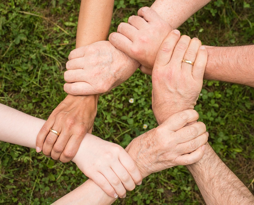Circle of hands holding each other by the wrist