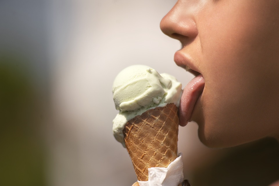 A person licking an ice cream cone