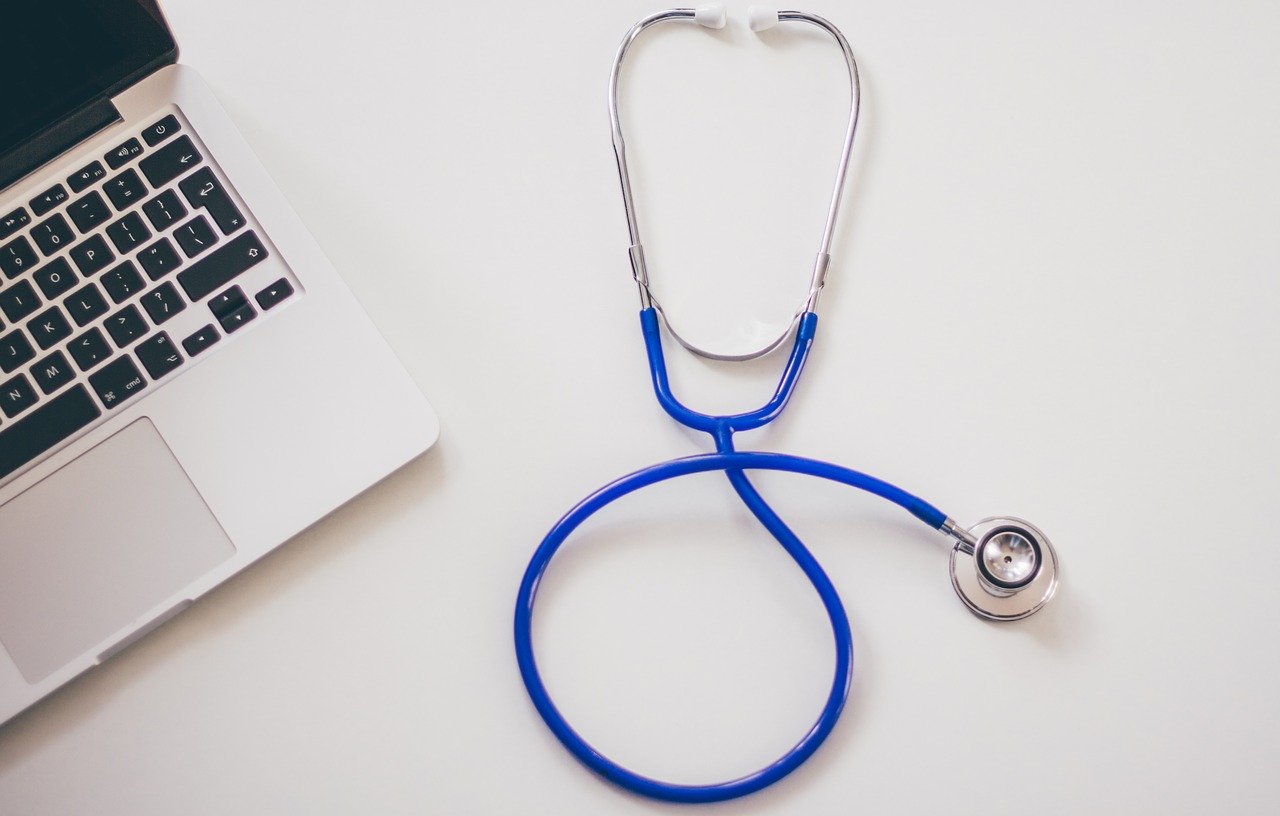 image of a stethoscope and a laptop computer