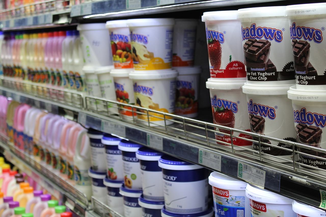 An aisle of dairy products in a supermarket.