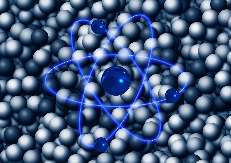 A blue line graphic of an atom, against a background of grey spheres