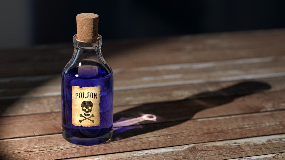 A bottle marked with a skull and crossbones, and the word poison, containing a dark purple liquid