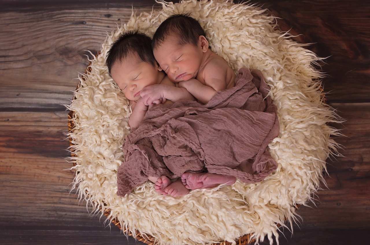 Two twin babies sleeping.