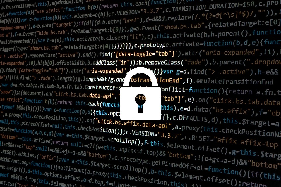 A padlock imposed over a screen of computer code