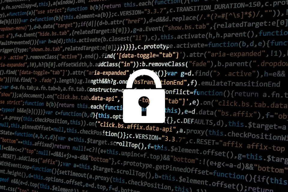 A padlock imposed over a screen of computer code