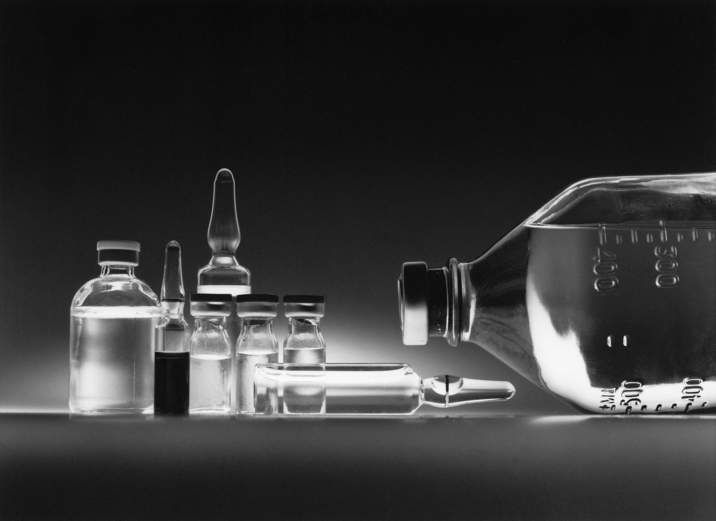 Variety of chemotherapy drugs in vials and an IV bottle.