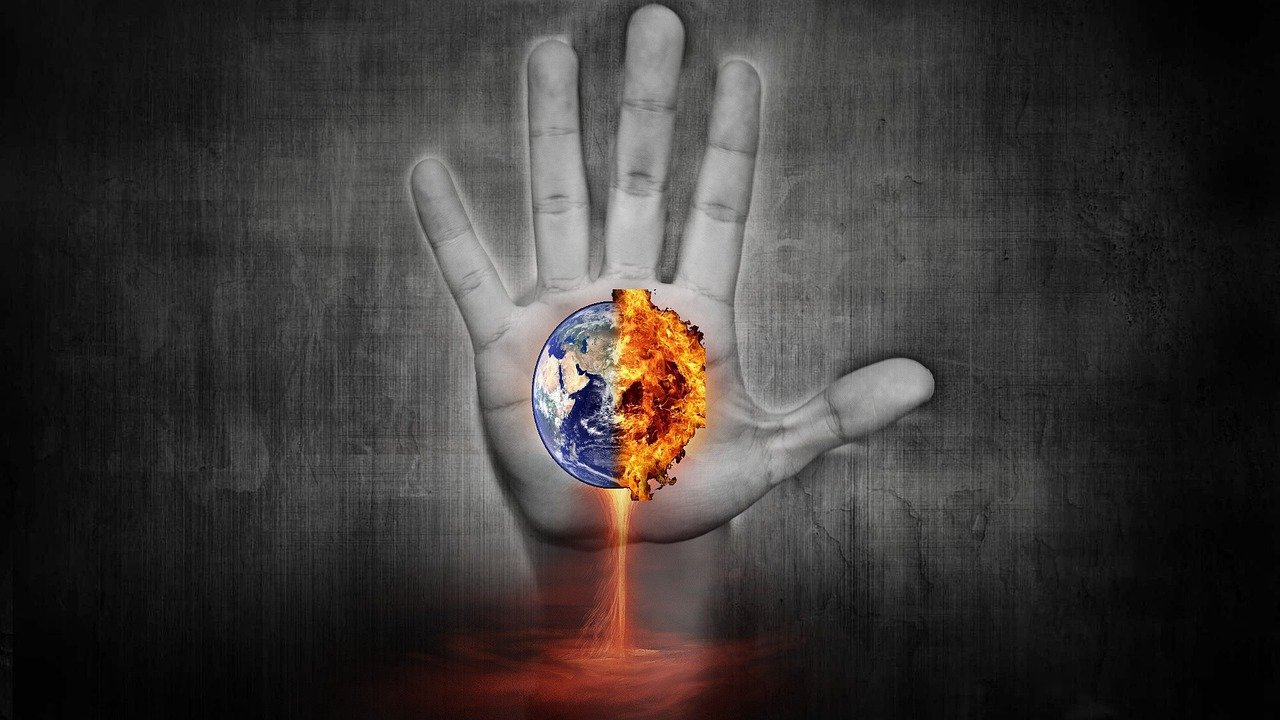 Cartoon hand holding a burning Earth
