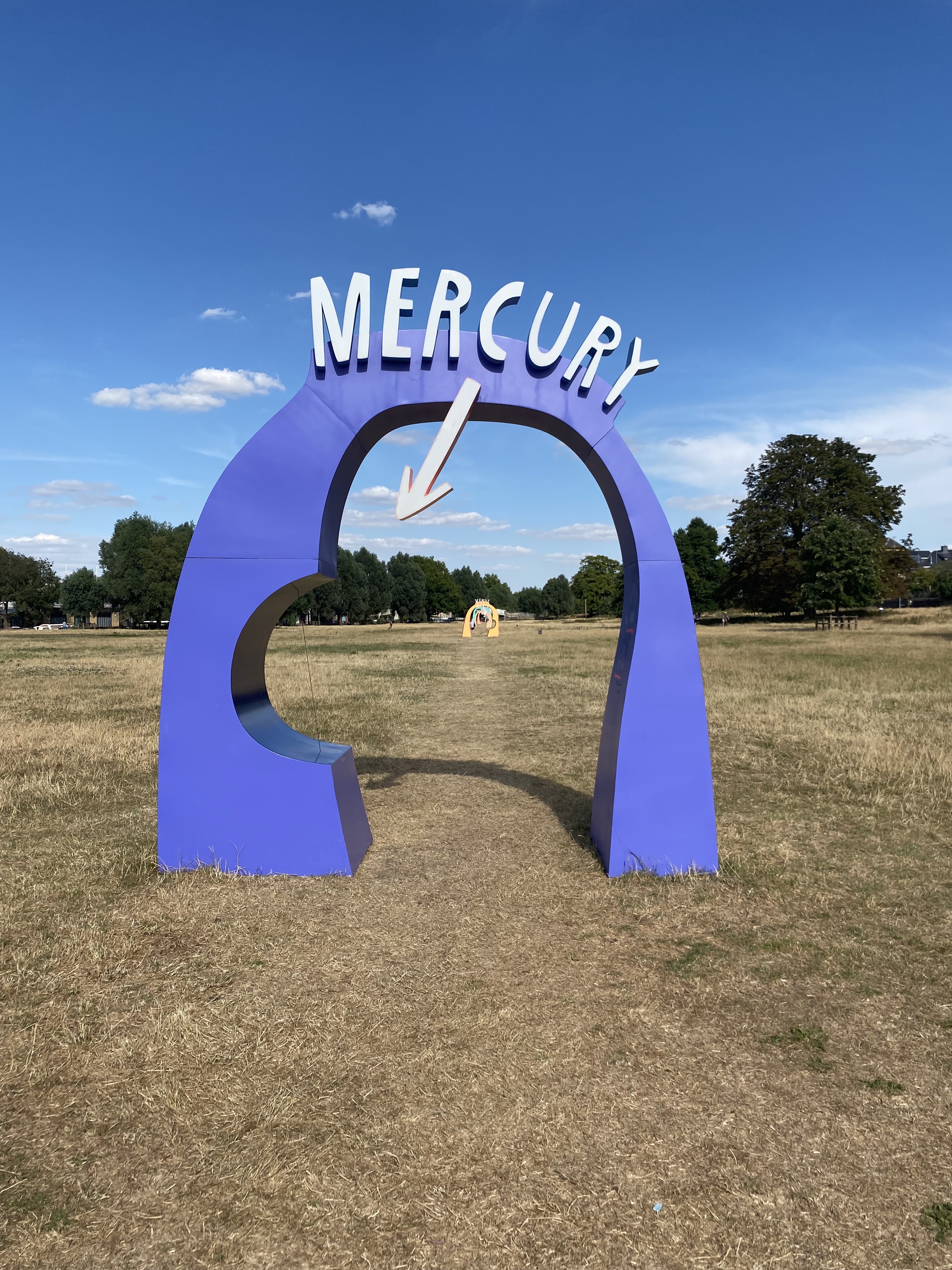 Purple arch with the word "Mercury" on top pointing to a tiny pea-sized planet