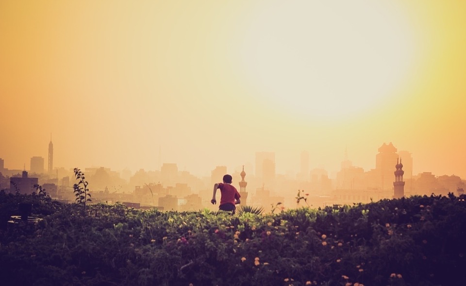 a child running away from the camera into the sunset
