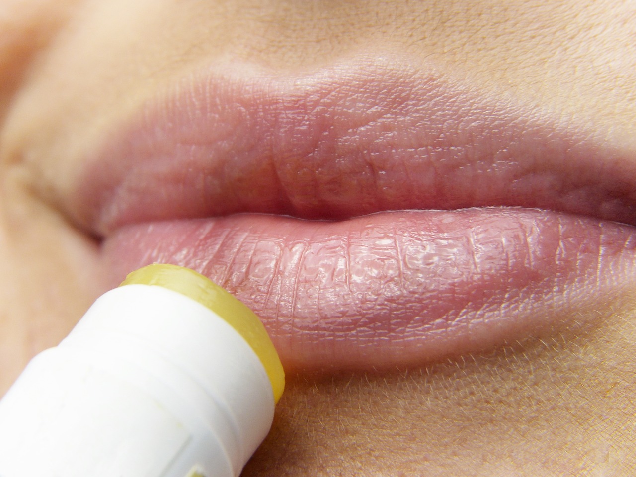 Woman applying lip balm