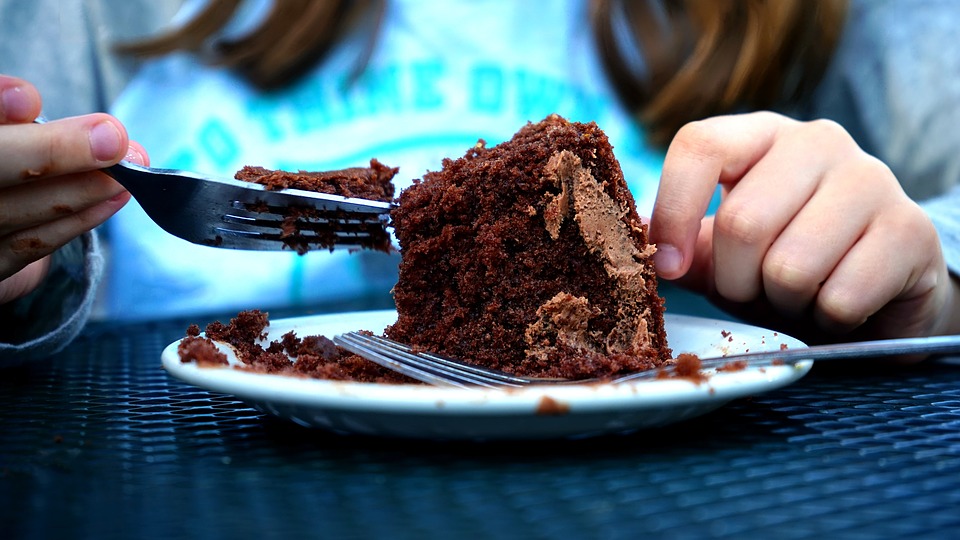 this is a picture of someone eating chocolate cake