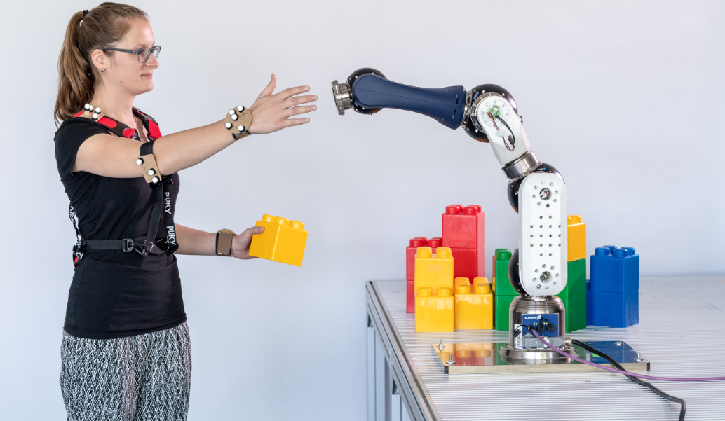 Human interacting with robot arm