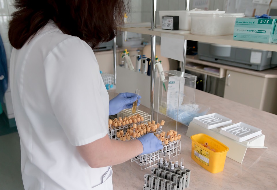 a scientist at a lab bench with samples