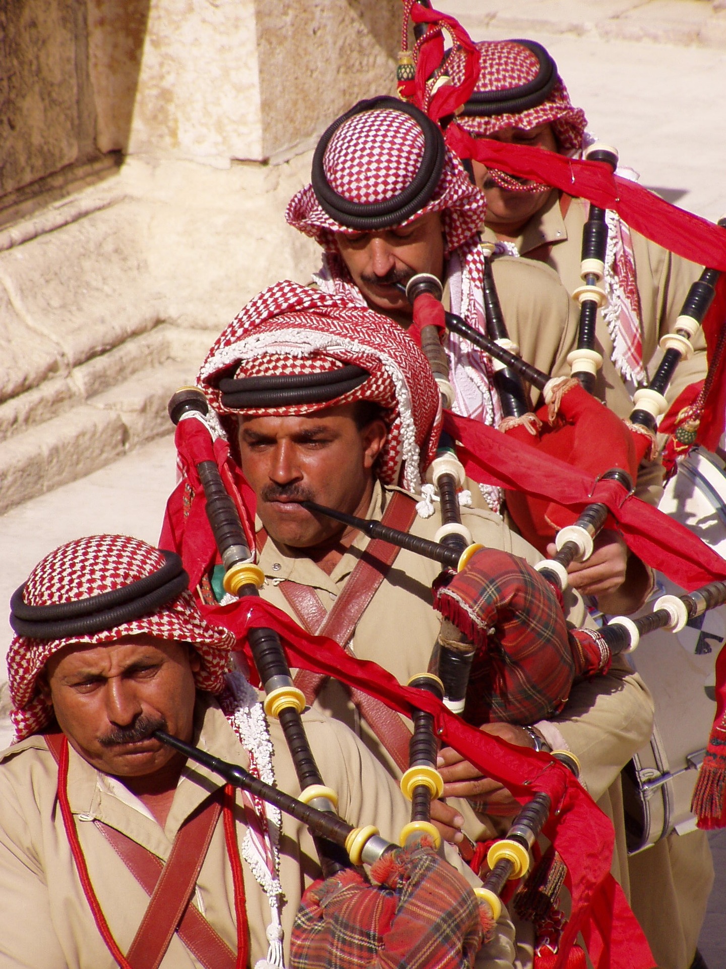 A line of men playing the bagpipes