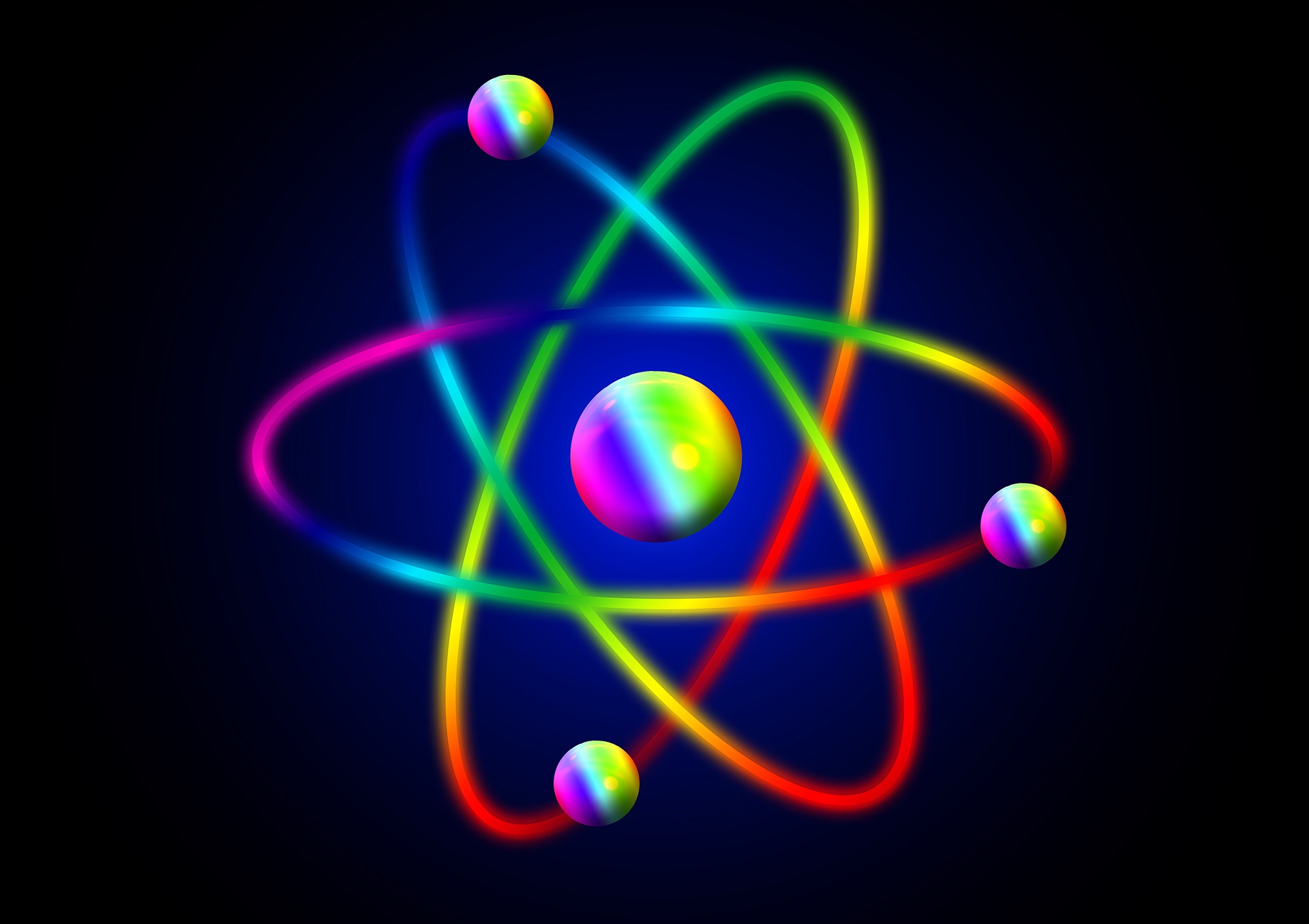 An atom graphic coloured with a rainbow gradient
