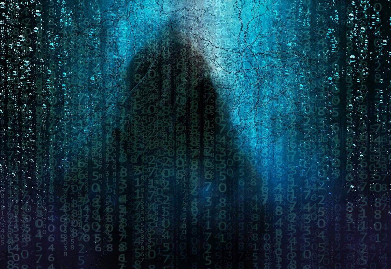 Lines of matrix-style green characters obscuring a hooded figure.