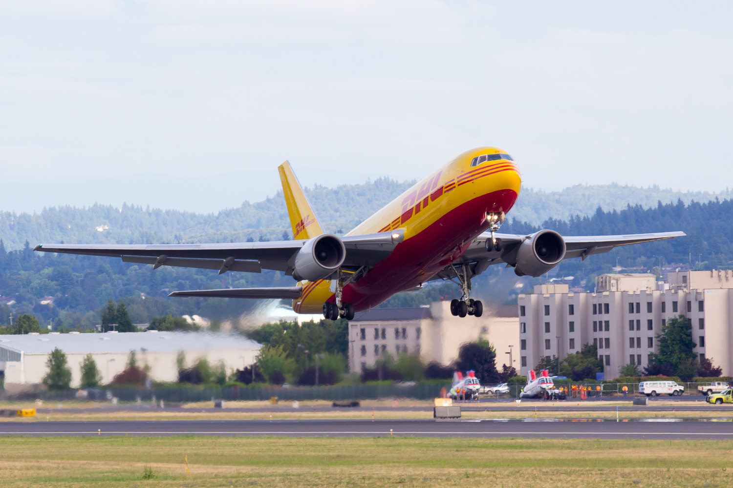 N785AX, a Boeing 767-200 in the DHL livery, operated by Airborne Express, departs runway 28R at Portland International Airport (KPDX).