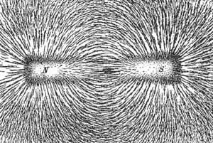 Magnetic lines of force of a bar magnet shown by iron filings on paper