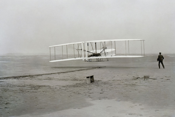  First successful flight of the Wright Flyer, by the Wright brothers. The machine traveled 120 ft (36.6 m) in 12 seconds at 10:35 a.m. at Kitty Hawk, North Carolina. Orville Wright was at the controls of the machine, lying prone on the lower wing with...