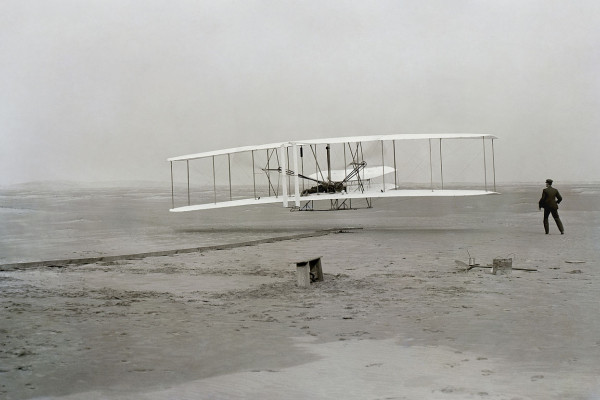 First successful flight of the Wright Flyer, by the Wright brothers. The machine traveled 120 ft (36.6 m) in 12 seconds at 10:35 a.m. at Kitty Hawk, North Carolina. Orville Wright was at the controls of the machine, lying prone on the lower wing with...
