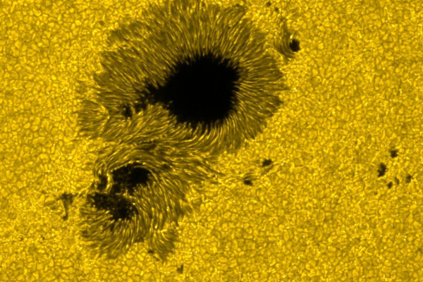 Granules-like structure of surface of sun and sunspots (size around 20'000km). Visible light. Taken by Hinode's Solar Optical Telescope (SOT).