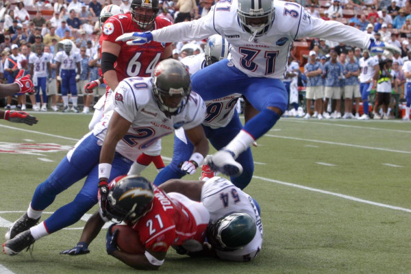 NFC defensive backs Ronde Barber and Roy Williams along with linebacker Jeremiah Trotter gang tackle AFC running back Ladainian Tomlinson during the 2006 Pro Bowl in Hawaii. More than 49,000 fans showed up to cheer on their favorite NFL players.