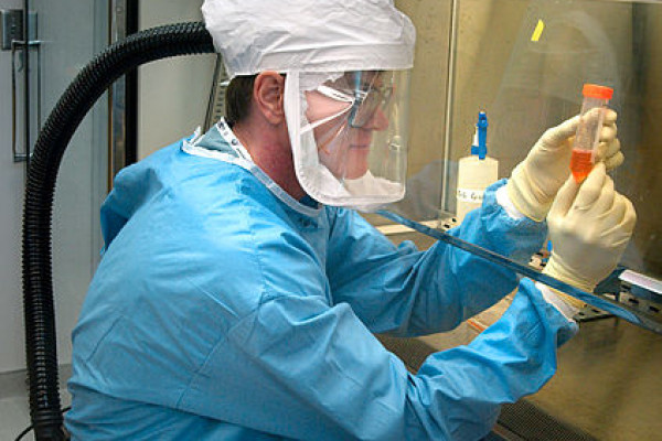  This 2005 photograph of the Centers for Disease Control and Preventions Dr. Terrence Tumpey, one of the organizations staff microbiologists and a member of the National Center for Infectious Diseases (NCID), showed him examining reconstructed 1918...